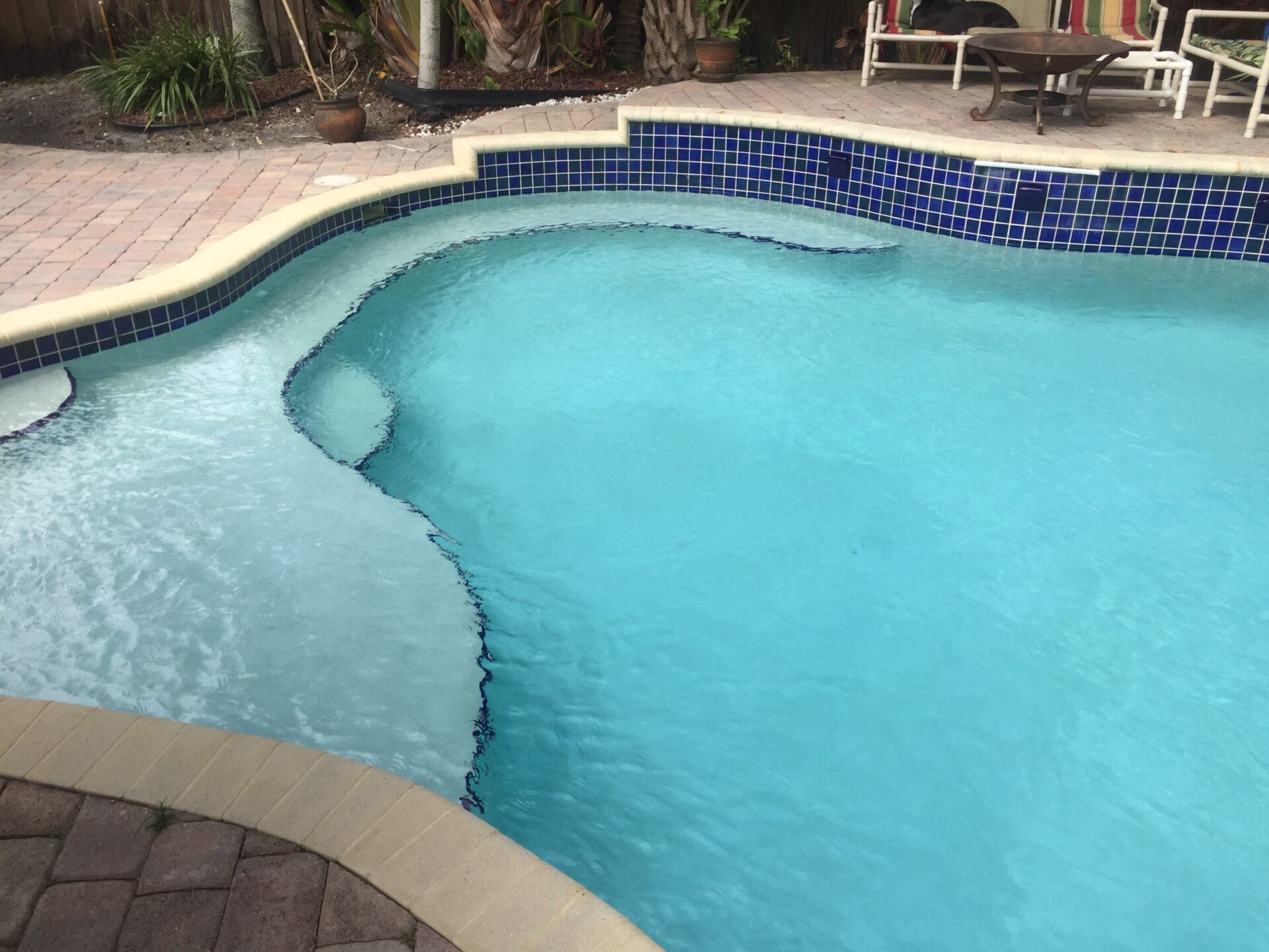 Close up view of rain drops during rainstorm falling onoutdoor swimming pool in Miami Florida